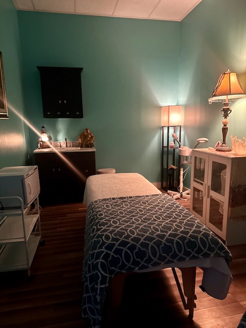 Cozy massage therapy room with calming lighting