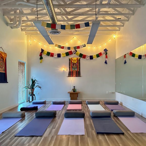 Yoga studio with mats and prayer flags